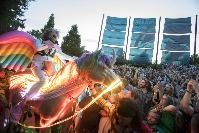Lead singer of the Flaming Lips rides an electric unicorn/Pegasus into crowd of enthusiastic guests